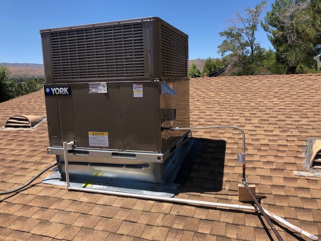 Professional HVAC contractor fixing a residential air conditioner.