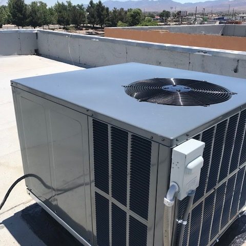 A silver color machine kept on a roof